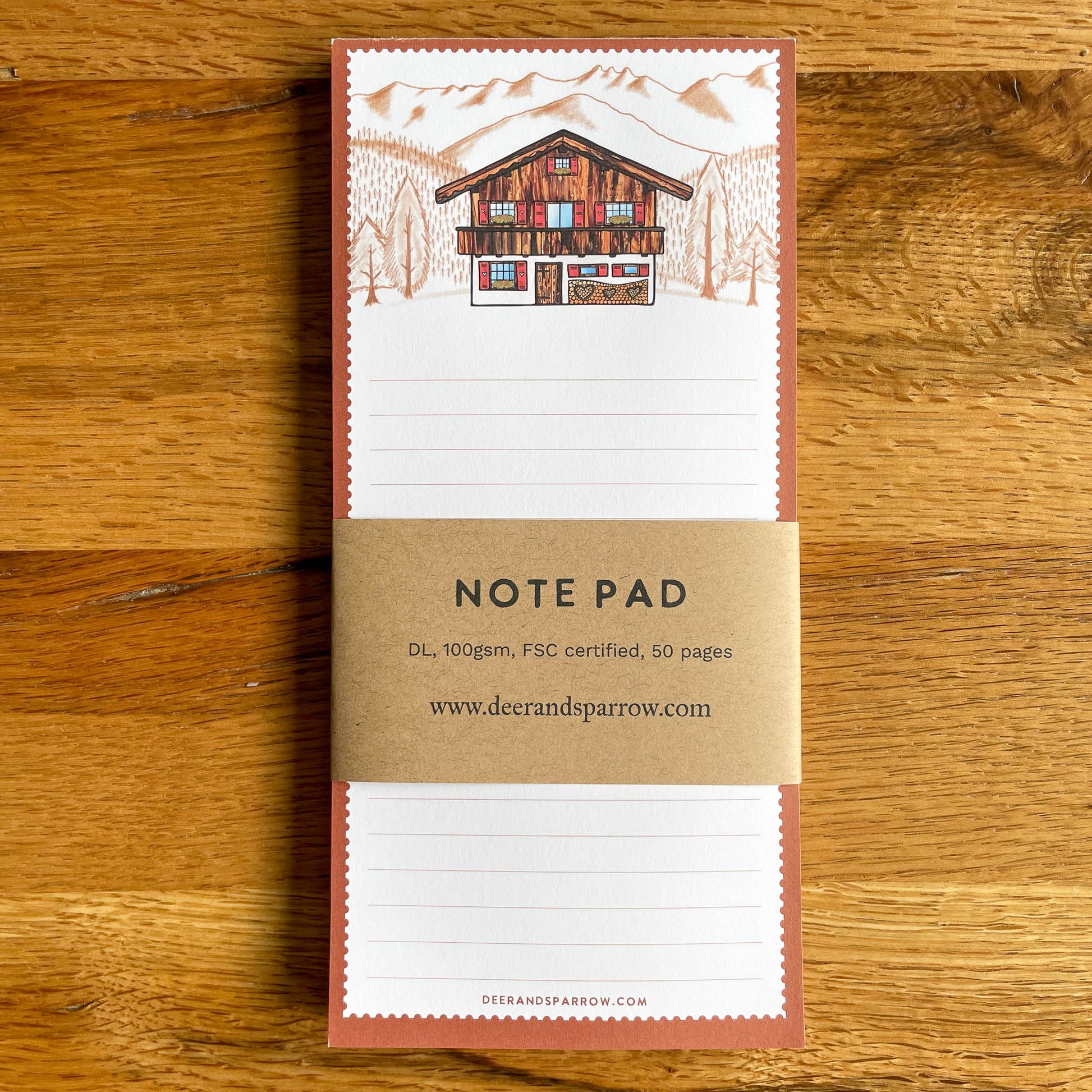 Bring a touch of alpine magic to your stationery collection with this adorable note pad, showcasing a Swiss chalet and breathtaking mountain scenery