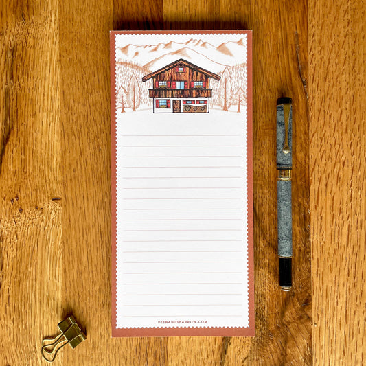 Note Pad featuring a charming Swiss chalet surrounded by majestic mountains